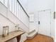Bright entryway with staircase, hardwood floors, and console table at 11616 Crest Creek Dr, Riverview, FL 33569