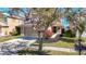 Tan two-story house with a two-car garage and manicured lawn at 11616 Crest Creek Dr, Riverview, FL 33569