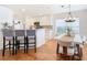Modern kitchen with white cabinets, breakfast bar, and stainless steel appliances at 11616 Crest Creek Dr, Riverview, FL 33569