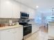 White kitchen with stainless steel appliances and a view to the dining area at 11616 Crest Creek Dr, Riverview, FL 33569