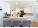 Modern kitchen with white cabinets, breakfast bar, and stainless steel appliances at 11616 Crest Creek Dr, Riverview, FL 33569