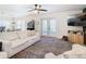 Living room with white sofa, access to backyard, and a wood accent wall at 11616 Crest Creek Dr, Riverview, FL 33569