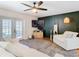 Living room with white sofas, access to backyard, and a dark accent wall at 11616 Crest Creek Dr, Riverview, FL 33569