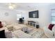 Bright living room with sectional sofa, large TV, and ample natural light at 11616 Crest Creek Dr, Riverview, FL 33569