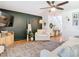 Bright living room features white sofas, a large TV, and a stylish rug at 11616 Crest Creek Dr, Riverview, FL 33569