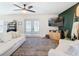 Living room featuring white sofas, a large TV, and French doors at 11616 Crest Creek Dr, Riverview, FL 33569