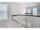 Elegant staircase with white railings and a chandelier at 11616 Crest Creek Dr, Riverview, FL 33569