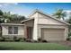 Modern one-story home with stone accents and a two-car garage at 11830 Starbright Path, Venice, FL 34293