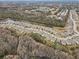 Aerial view of a residential community with houses, trees, and a lake at 13456 Marble Sands Ct, Hudson, FL 34669