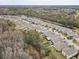 Aerial view of houses, trees, and a pond in a quiet residential neighborhood at 13456 Marble Sands Ct, Hudson, FL 34669