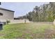 Spacious backyard with grassy area, privacy fence, and shed at 13456 Marble Sands Ct, Hudson, FL 34669