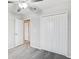 Bedroom with ceiling fan and access to bathroom at 13456 Marble Sands Ct, Hudson, FL 34669