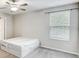 Spacious bedroom with large window and ceiling fan at 13456 Marble Sands Ct, Hudson, FL 34669