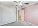 Bedroom with pink accent wall and access to bathroom at 13456 Marble Sands Ct, Hudson, FL 34669