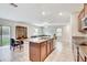 Open kitchen with island, granite counters and dark wood cabinets at 13456 Marble Sands Ct, Hudson, FL 34669