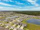 Aerial view of a residential neighborhood near a lake at 13580 Willow Bluestar Loop, Riverview, FL 33579