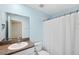 Bathroom with light blue walls, granite countertop, and a shower at 13580 Willow Bluestar Loop, Riverview, FL 33579