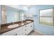 Bathroom with double vanity, light blue walls and tile floor at 13580 Willow Bluestar Loop, Riverview, FL 33579
