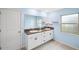 Bathroom with double vanity, light blue walls and tile floor at 13580 Willow Bluestar Loop, Riverview, FL 33579