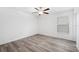 Simple bedroom with wood-look floors and a ceiling fan at 13580 Willow Bluestar Loop, Riverview, FL 33579