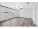 Spacious bedroom with ceiling fan and grey vinyl plank flooring at 13580 Willow Bluestar Loop, Riverview, FL 33579
