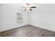 Bright bedroom with wood-look floors and a window with blinds at 13580 Willow Bluestar Loop, Riverview, FL 33579