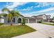 Two story house with palm trees and a three car garage at 13580 Willow Bluestar Loop, Riverview, FL 33579