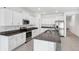 Modern kitchen with white cabinets, granite counters, and stainless steel appliances at 13580 Willow Bluestar Loop, Riverview, FL 33579