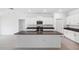 Modern kitchen with white cabinets, granite countertops and stainless steel appliances at 13580 Willow Bluestar Loop, Riverview, FL 33579