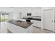 Modern kitchen with white cabinets, granite counters and stainless steel appliances at 13580 Willow Bluestar Loop, Riverview, FL 33579