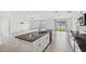 Modern kitchen with white cabinets, granite counters, and stainless steel appliances at 13580 Willow Bluestar Loop, Riverview, FL 33579