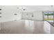 Bright living room with tile floors and sliding glass doors leading to backyard at 13580 Willow Bluestar Loop, Riverview, FL 33579