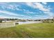 View of a pond from a backyard with a white fence at 13580 Willow Bluestar Loop, Riverview, FL 33579