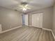 Large bedroom with ceiling fan and light grey flooring at 1412 Columbia Ave, Palm Harbor, FL 34683