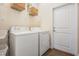 Bright laundry room with washer, dryer, and extra shelving at 14356 Edinburgh Moor Dr, Wimauma, FL 33598