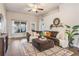 Relaxing living room featuring a sectional sofa and large windows at 14356 Edinburgh Moor Dr, Wimauma, FL 33598