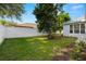 Spacious backyard with grassy area and white fence at 15214 Octavia Ln, Odessa, FL 33556