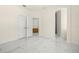 Bedroom with white doors and marble floors at 15214 Octavia Ln, Odessa, FL 33556