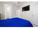 Bedroom with a blue comforter and a large TV at 15214 Octavia Ln, Odessa, FL 33556