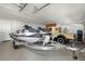 Garage with two jet skis, classic car, and storage at 15214 Octavia Ln, Odessa, FL 33556