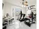 Home gym includes a treadmill, weight machine, and office workspace at 15214 Octavia Ln, Odessa, FL 33556
