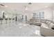 Open living room boasts spacious layout, large sectional sofa, and marble flooring at 15214 Octavia Ln, Odessa, FL 33556