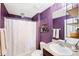 Purple bathroom with shower tub and updated vanity at 17071 Oval Rum Dr, Wimauma, FL 33598