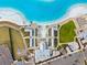 Aerial view of a beach club with a pool and cabanas at 17071 Oval Rum Dr, Wimauma, FL 33598