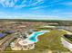 Aerial view of a crystal lagoon amenity with beach and seating at 17071 Oval Rum Dr, Wimauma, FL 33598