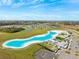Aerial view of a large crystal lagoon with surrounding community at 17071 Oval Rum Dr, Wimauma, FL 33598
