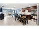 Open concept kitchen with dark brown cabinets, granite countertops, and stainless steel appliances at 17071 Oval Rum Dr, Wimauma, FL 33598