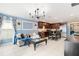 Living room features a light gray couch and a large black chandelier at 17071 Oval Rum Dr, Wimauma, FL 33598