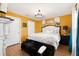 Spacious main bedroom with a king-size bed and mustard-yellow walls at 17071 Oval Rum Dr, Wimauma, FL 33598