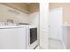 Laundry room with washer, dryer, and shelving at 1748 Paladino Ct, Odessa, FL 33556